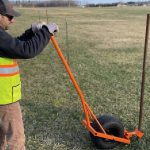 A New York highway superintendent built a snow-fence pole remover from an old golf-cart wheel and scrap box tubing for $0; it cut a three-week job to about 1.5 weeks and has now won a national federal award