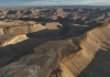 Utah approved blasting 100-foot canyon cliffs to widen a 5.3-mile road for oil trucks; after two earlier plans failed, a new federal lawsuit says 47 historic sites and 19th-century inscriptions are at risk